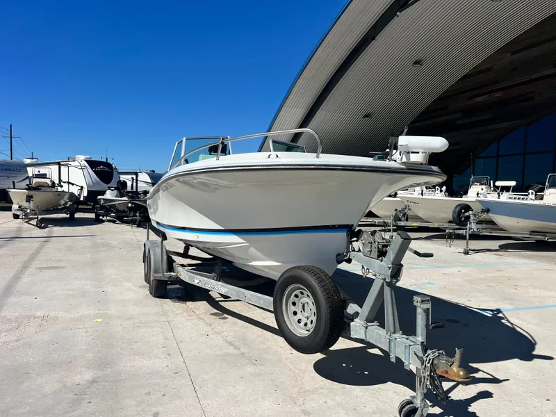 Slide: The Image of 1986 Wellcraft 20 SPORT FISH boat on a trailer in a marina. - 3