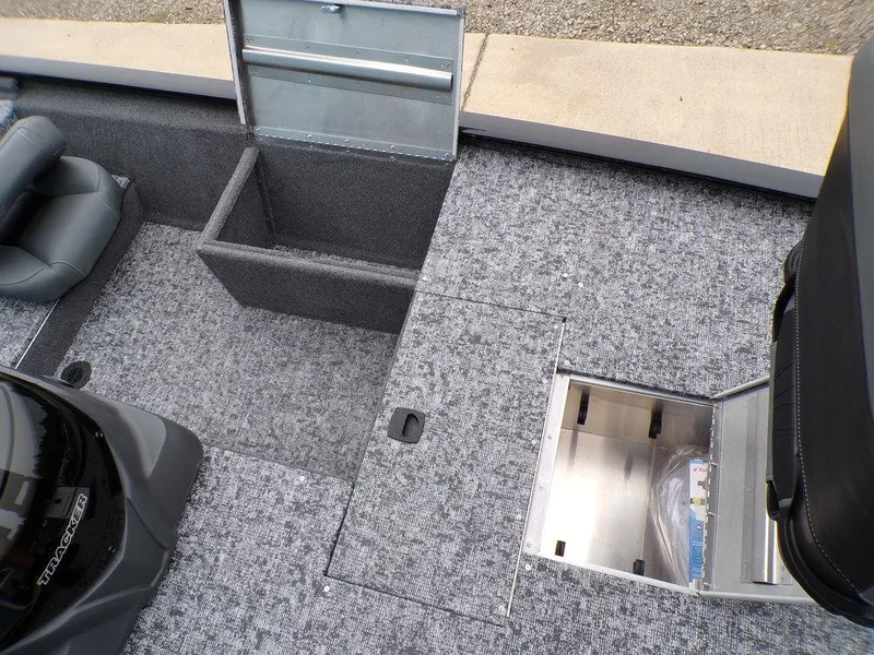 Slide: The Image of 2025 Tracker Pro 170 boat interior with open storage compartments and gray carpeted flooring. - 14