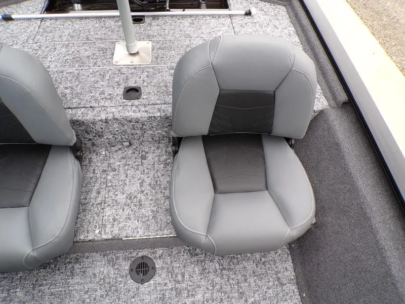 Slide: The Image of 2025 Tracker Pro 170 boat interior with gray seating and textured flooring. - 19