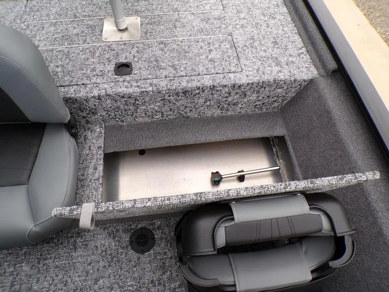 Slide: The Image of 2025 Tracker Pro 170 boat interior with open storage compartment and seating. - 20