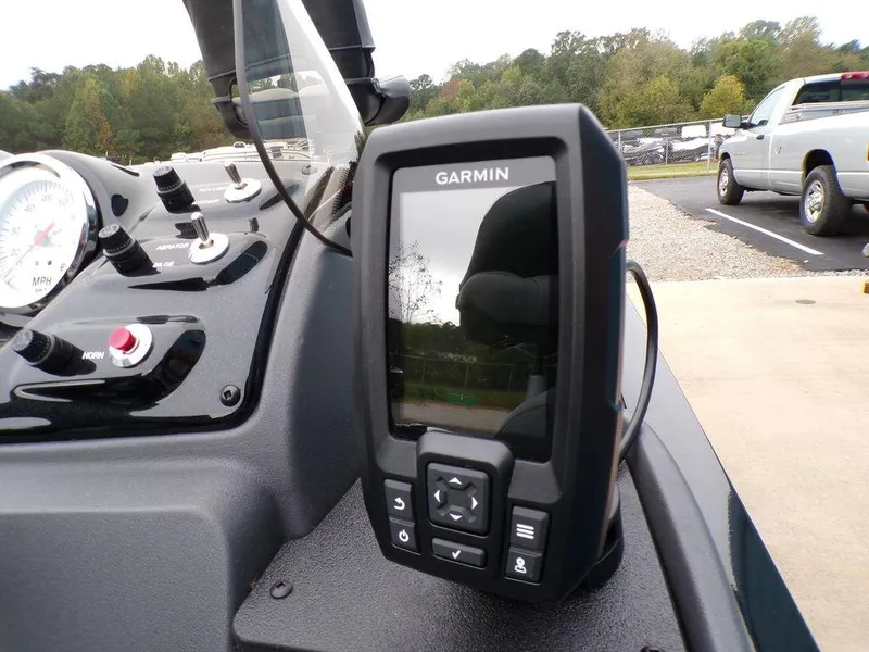 Slide: The Image of Garmin GPS device on 2025 Tracker Pro 170 boat dashboard, with control panel and outdoor background. - 26