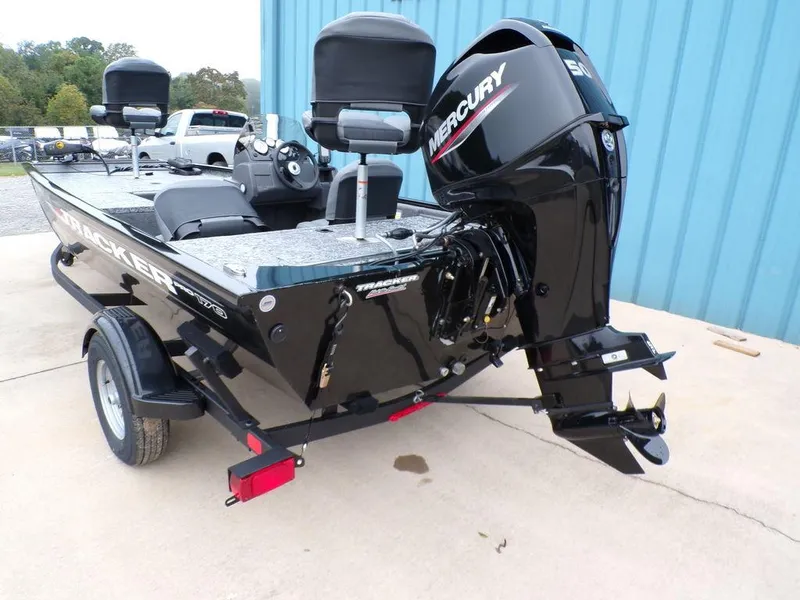 Slide: The Image of 2025 Tracker Pro 170 boat with Mercury engine, parked on a trailer near a blue building. - 5