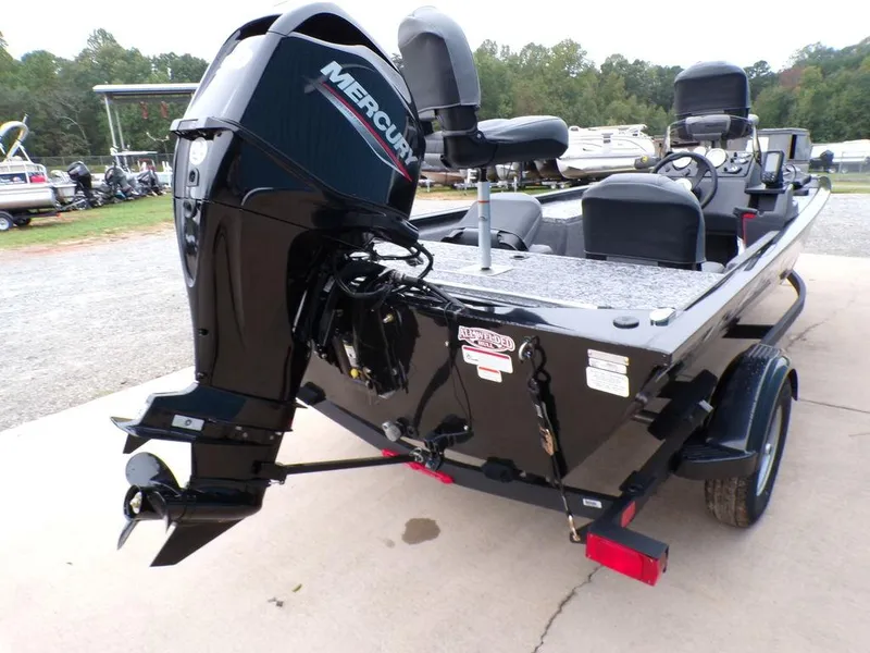 Slide: The Image of 2025 Tracker Pro 170 boat with Mercury outboard motor, parked on a trailer. - 6