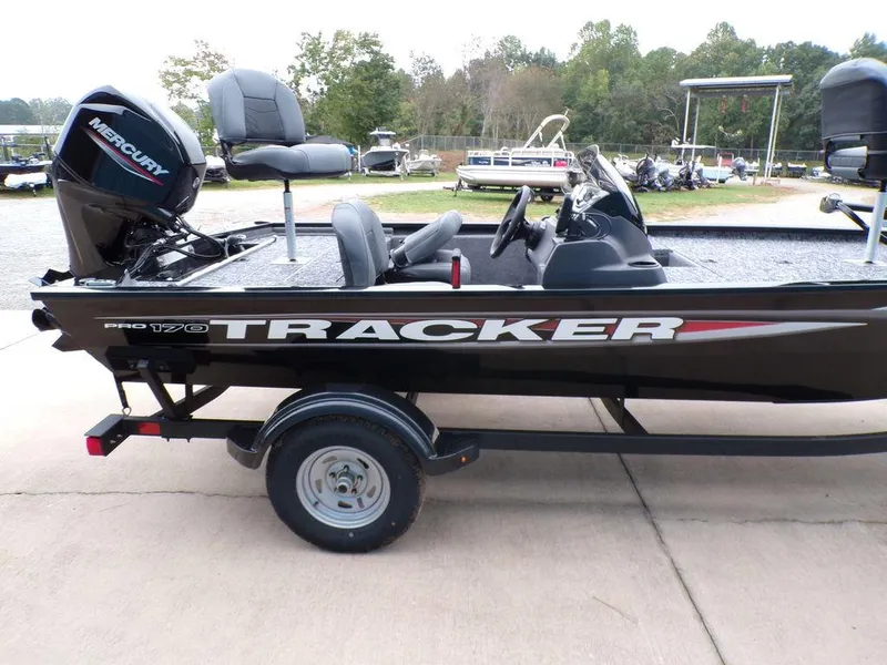 Slide: The Image of 2025 Tracker Pro 170 boat with Mercury engine on a trailer, parked outdoors. - 7