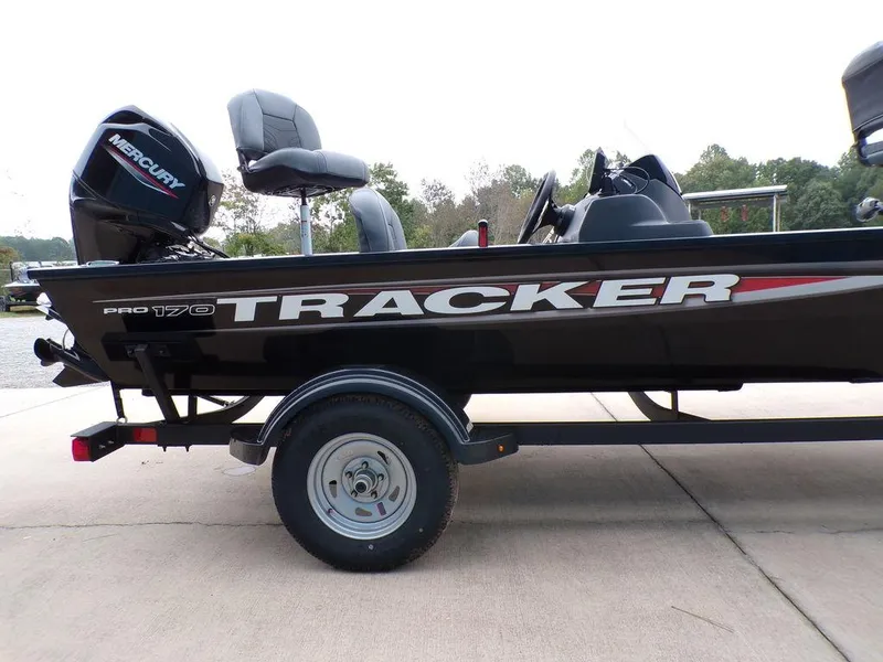 Slide: The Image of 2025 Tracker Pro 170 boat on trailer, featuring Mercury engine, parked outdoors. - 9