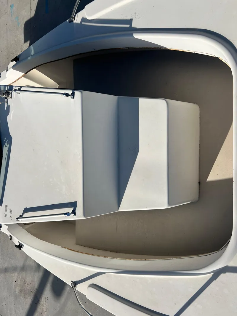 Slide: The Image of 1984 Dusky 233 boat docked at a marina, aerial view. - 11