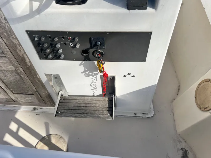 Slide: The Image of Control panel of a 1984 Dusky 233 boat with ignition key and switches. - 16