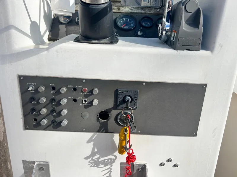Slide: The Image of 1984 Dusky 233 boat dashboard with steering wheel, gauges, and storage compartment. - 17
