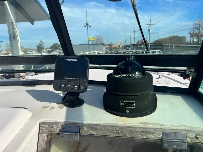 Slide: The Image of Interior cabin of a 1984 Dusky 233 boat with life preserver and fender. - 19