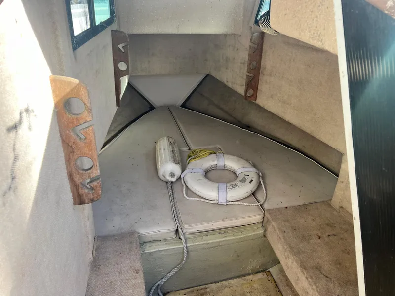 Slide: The Image of Interior cabin of a 1984 Dusky 233 boat with life preserver and fender. - 20