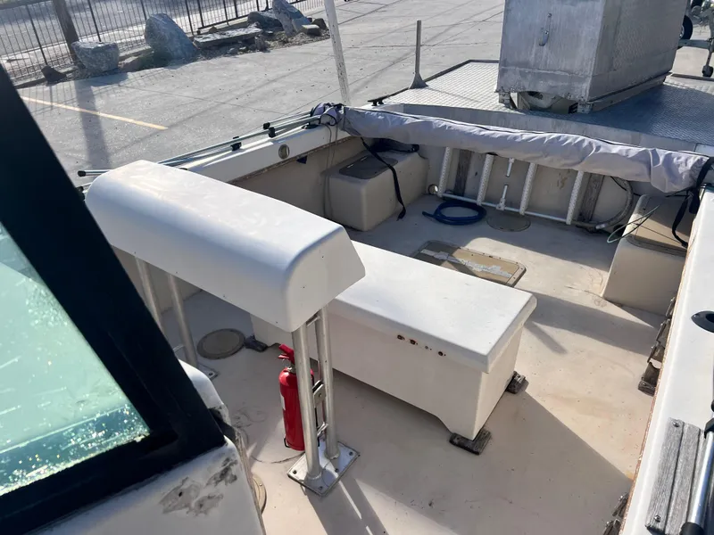 Slide: The Image of 1984 Dusky 233 boat interior, showing seating and storage compartments. - 24