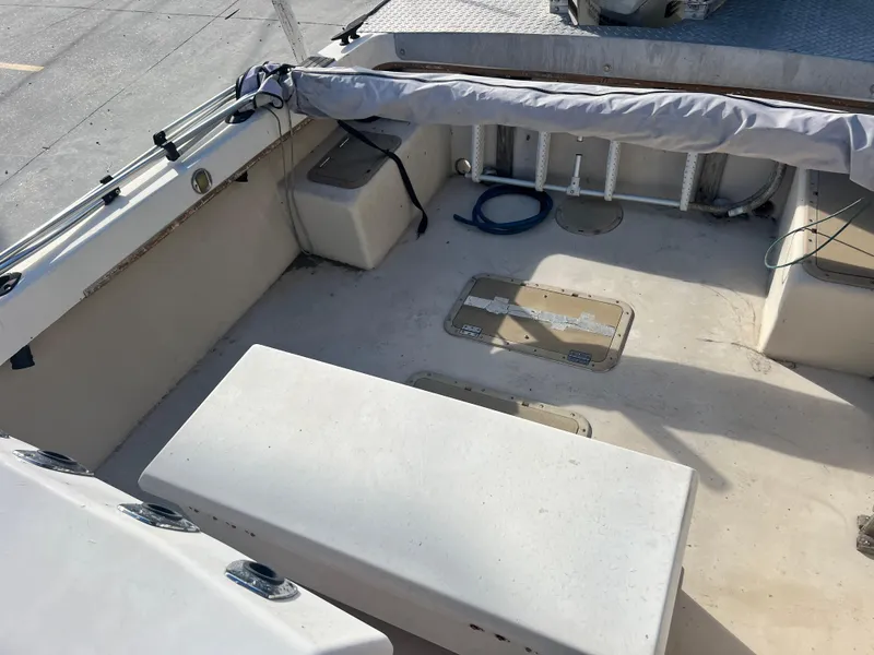 Slide: The Image of 1984 Dusky 233 boat, rear view, docked with other boats in the background. - 25