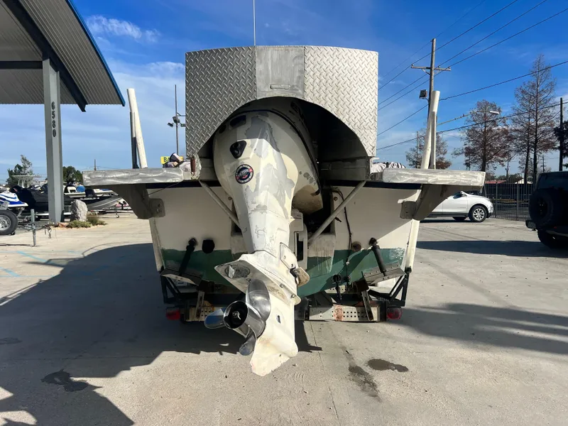Slide: The Image of 1984 Dusky 233 boat on a trailer in a marina. - 8
