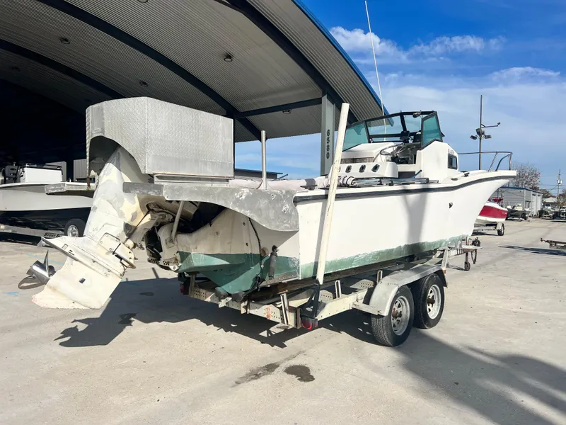 Slide: The Image of 1984 Dusky 233 boat bow with railing and storage hatch. - 9