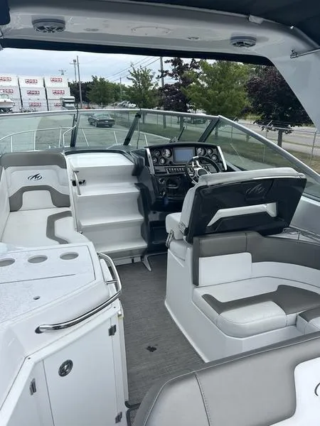 Slide: The Image of 2019 Monterey 295SY boat interior with helm, seating, and dashboard. - 16