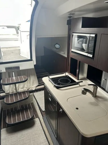 Slide: The Image of Interior of 2019 Monterey 295SY boat with kitchenette and stairs. - 18