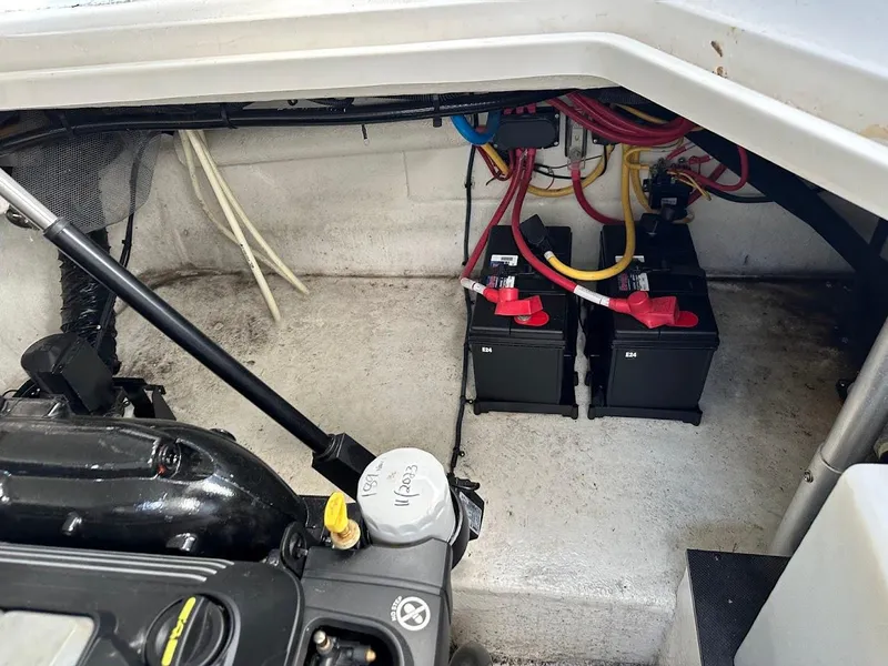 Slide: The Image of 2019 Monterey 295 SY engine compartment with dual batteries and wiring. - 24