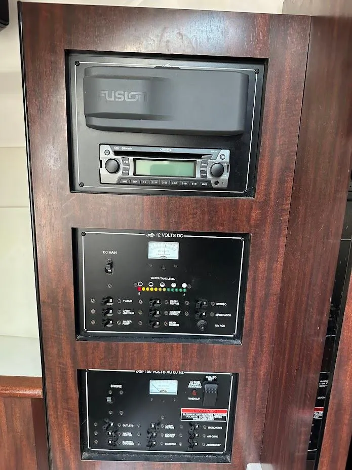 Slide: The Image of Control panel of a 2019 Monterey 295 SY boat with audio system and switches. - 26