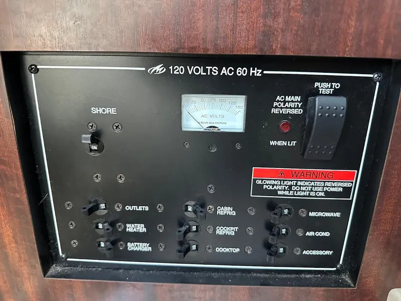 Slide: The Image of Control panel of a 2019 Monterey 295 SY boat, showing electrical switches and warnings. - 27