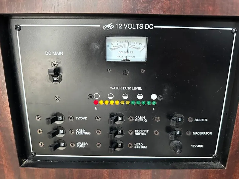Slide: The Image of Control panel of a 2019 Monterey 295 SY boat, showing DC voltage and water tank levels. - 28