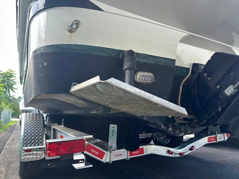 Slide: The Image of 2019 Monterey 295 SY boat on trailer, rear view showing hull and trim tabs. - 3