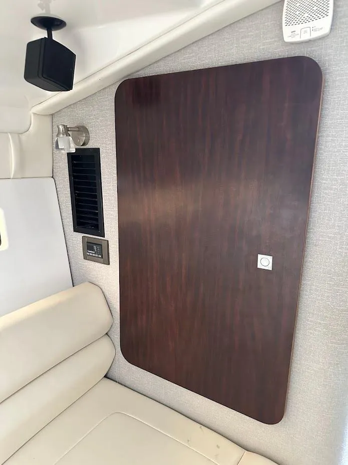 Slide: The Image of Interior of 2019 Monterey 295 SY boat with wood panel and beige seating. - 31