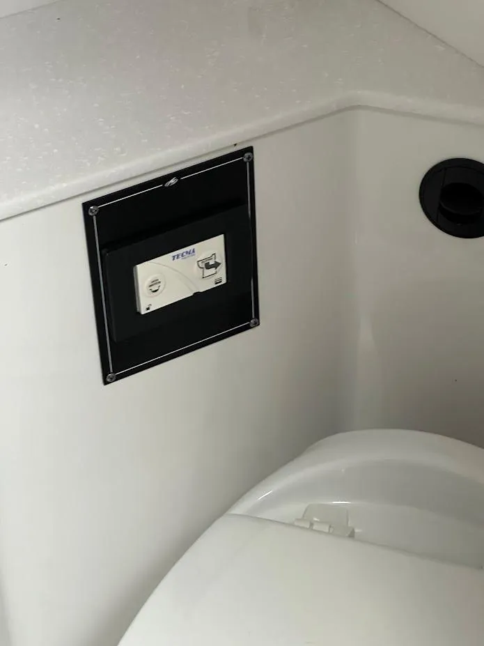 Slide: The Image of 2019 Monterey 295 SY boat interior with control panel and toilet. - 34