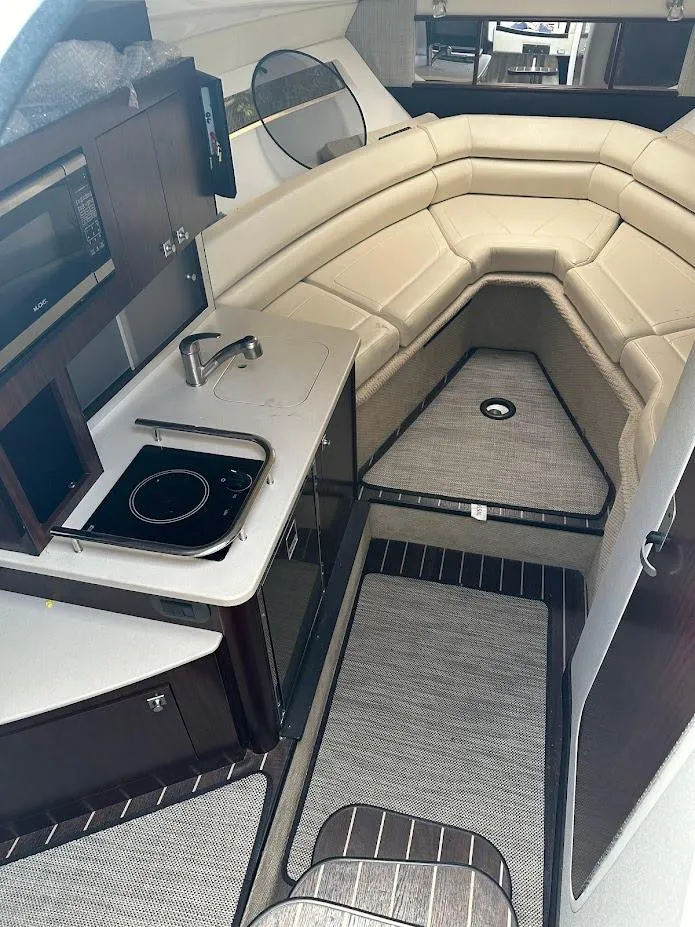 Slide: The Image of Interior of 2019 Monterey 295 SY boat with kitchenette and seating area. - 35