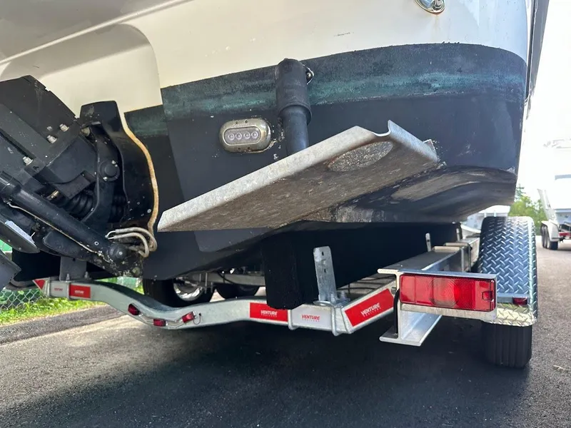 Slide: The Image of 2019 Monterey 295 SY boat on trailer, rear view showing propeller and trim tabs. - 4