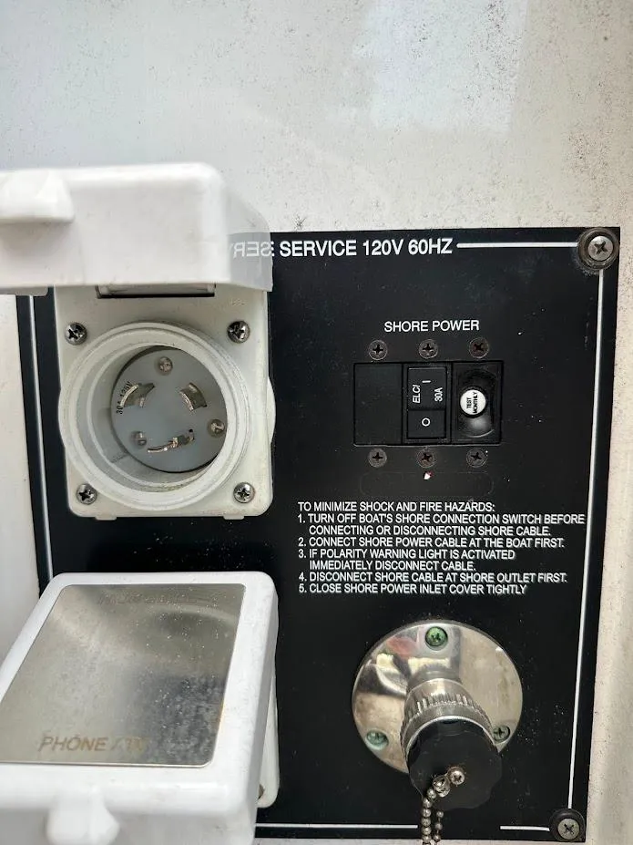 Slide: The Image of 2019 Monterey 295 SY shore power connection panel with safety instructions. - 40