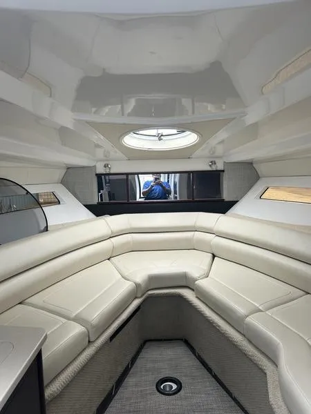 Slide: The Image of Interior of a 2019 Monterey 295SY boat with white leather seating. - 8