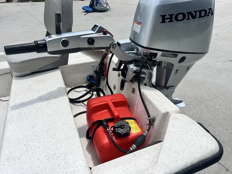 Slide: The Image of Boat with Honda outboard motor and red fuel tank, Custom model 14, year 2023. - 18