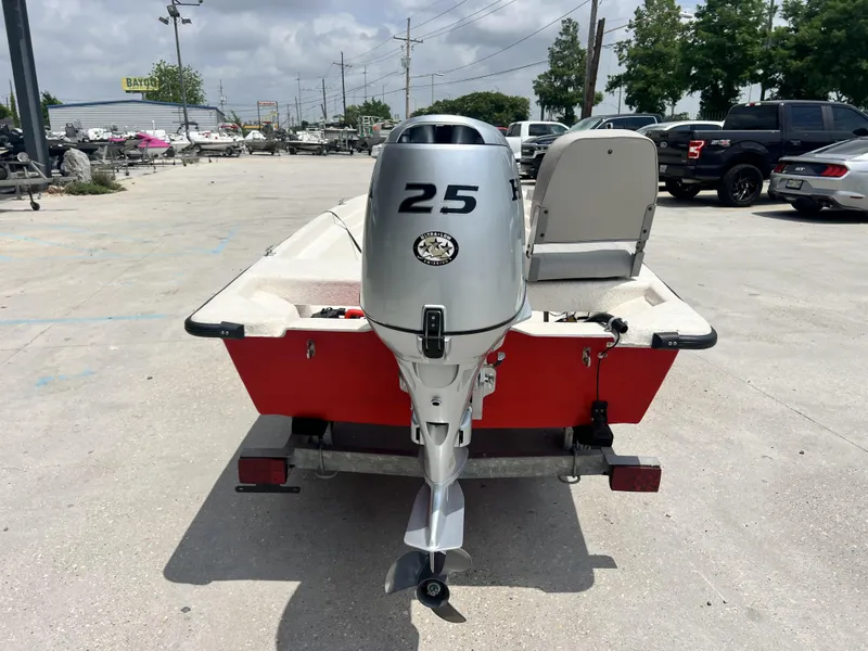 Slide: The Image of Custom 14 boat, 2023 model, with a 25 HP outboard motor, parked in a lot. - 5