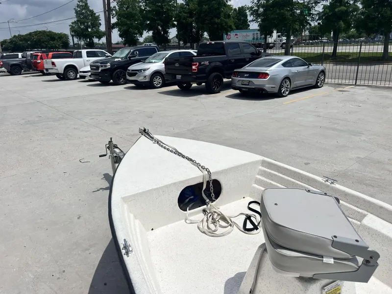 Slide: The Image of Boat on trailer in parking lot with various parked vehicles, Custom 14 model, 2023. - 6