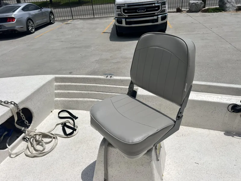 Slide: The Image of Gray boat seat on a Custom 14 model, 2023, with parking lot in background. - 7