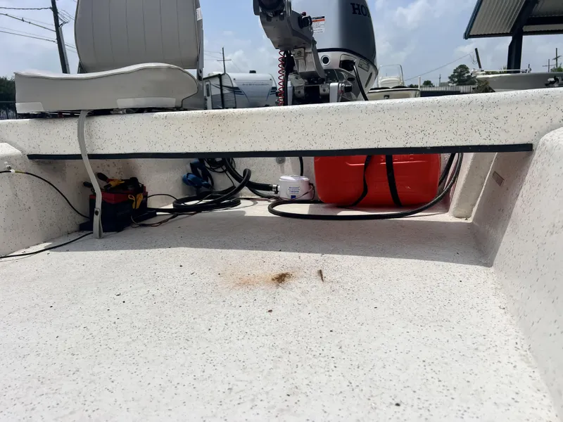 Slide: The Image of Interior of a 2023 Custom 14 boat with Honda outboard motor and equipment. - 9