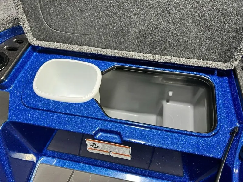 Slide: The Image of 2025 Nitro Z19 Pro boat storage compartment with blue interior and white container. - 21
