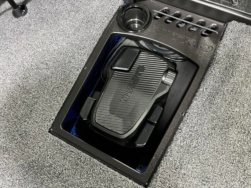 Slide: The Image of Nitro Z19 Pro 2025 foot pedal in a textured compartment with cup holder. - 25