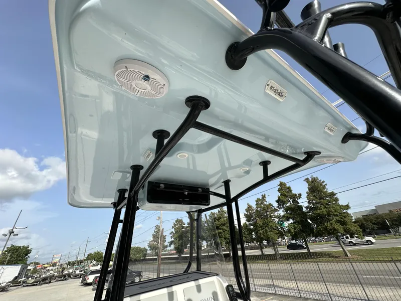 Slide: The Image of 2023 Sea Cat 262 boat with T-top and speakers, docked outdoors. - 12