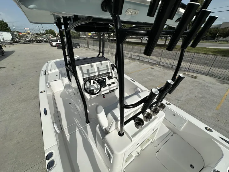 Slide: The Image of 2023 Sea Cat 262 boat interior with steering console and rod holders. - 14
