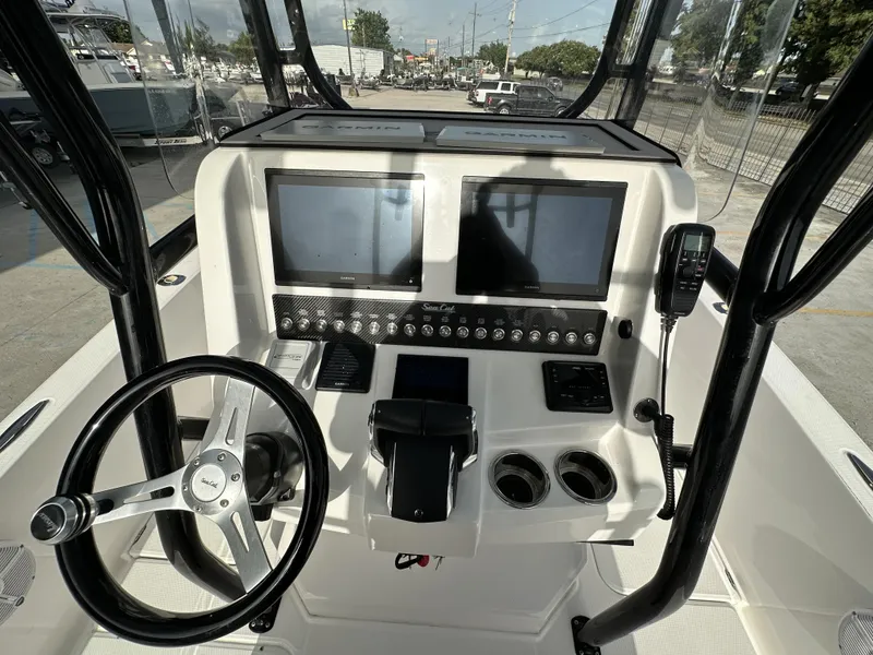 Slide: The Image of 2023 Sea Cat 262 boat dashboard with Garmin navigation system and steering wheel. - 15