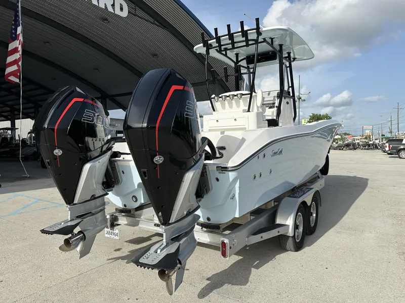 Slide: The Image of 2023 Sea Cat 262 boat with twin engines on a trailer. - 2