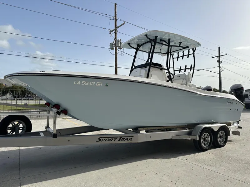 Slide: The Image of 2023 Sea Cat 262 boat on a Sport Trail trailer, parked outdoors. - 4