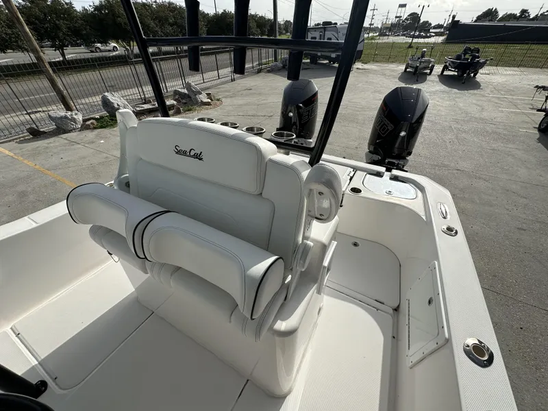Slide: The Image of 2023 Sea Cat 262 boat interior with dual outboard motors and white seating. - 8