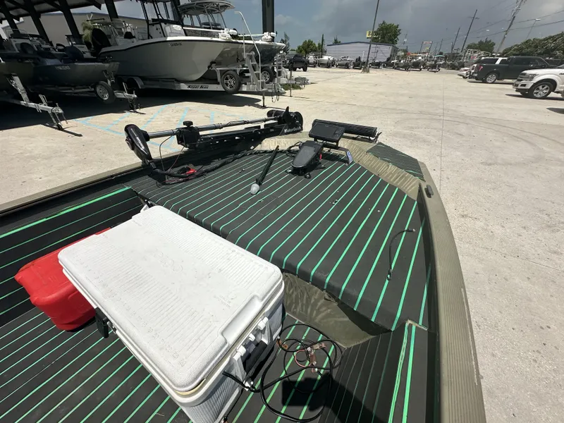 Slide: The Image of 2016 Tracker 1648 boat with accessories and equipment on deck in a parking lot. - 4