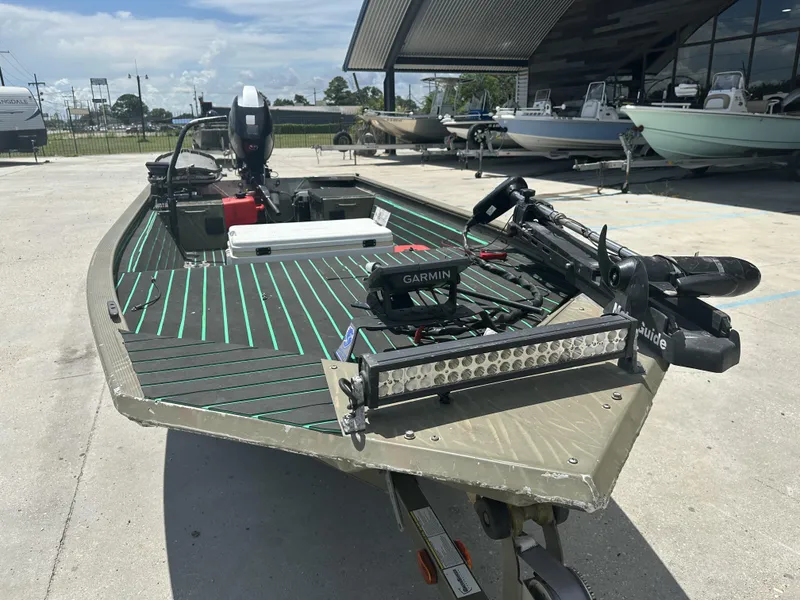 Slide: The Image of 2016 Tracker 1648 boat with Garmin equipment and outboard motor in a marina. - 9
