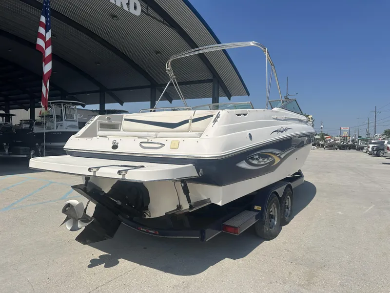 Slide: The Image of 2003 Rinker 282 Captiva boat on trailer, parked outside dealership. - 1