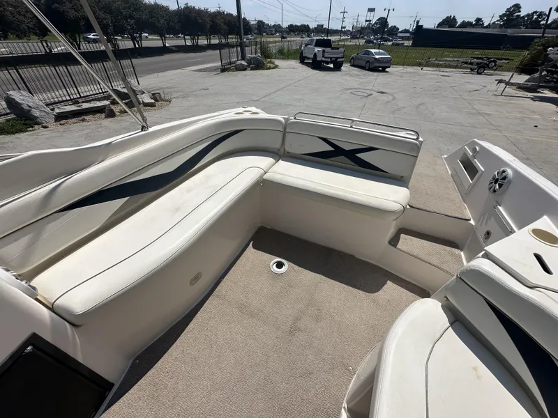Slide: The Image of 2003 Rinker 282 Captiva boat interior with white seating and carpeted floor. - 10