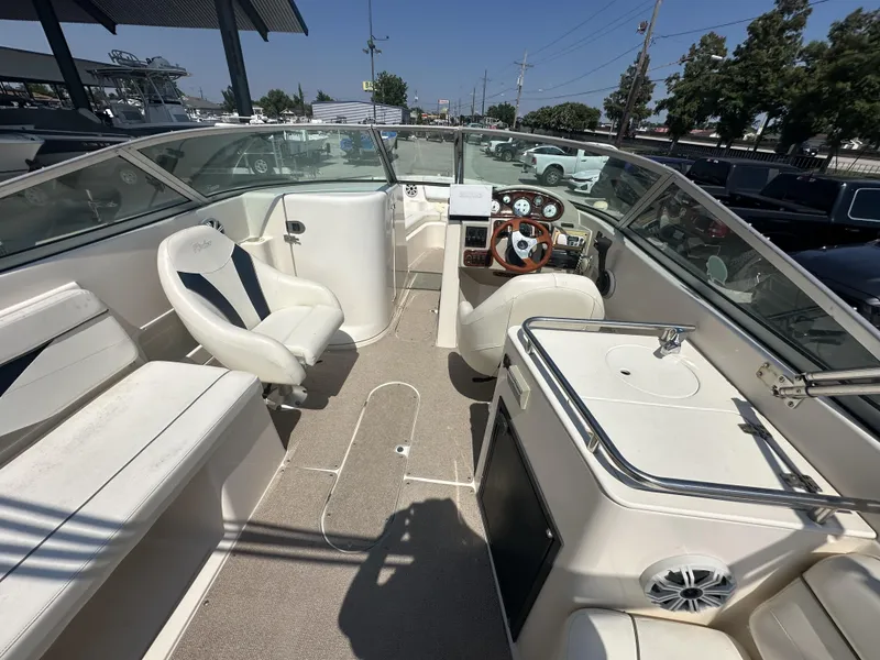 Slide: The Image of 2003 Rinker 282 Captiva boat interior with helm, seating, and sink. - 11