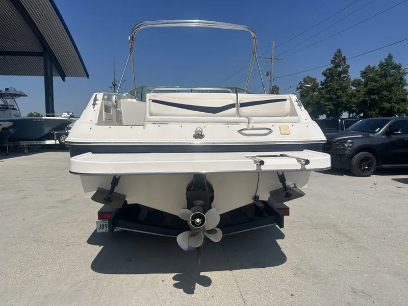 Slide: The Image of 2003 Rinker 282 Captiva boat rear view at a marina. - 3